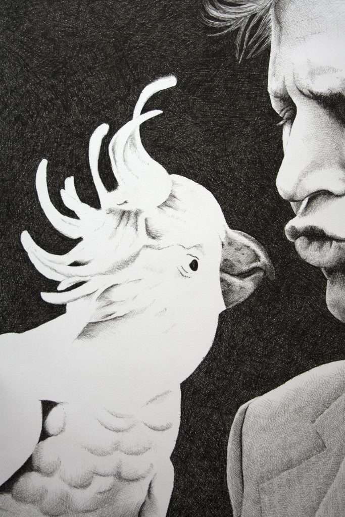 Close up of David Attenborough kissing a cockatoo