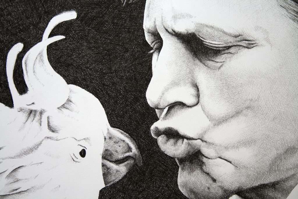 Portrait of David Attenborough kissing a cockatoo