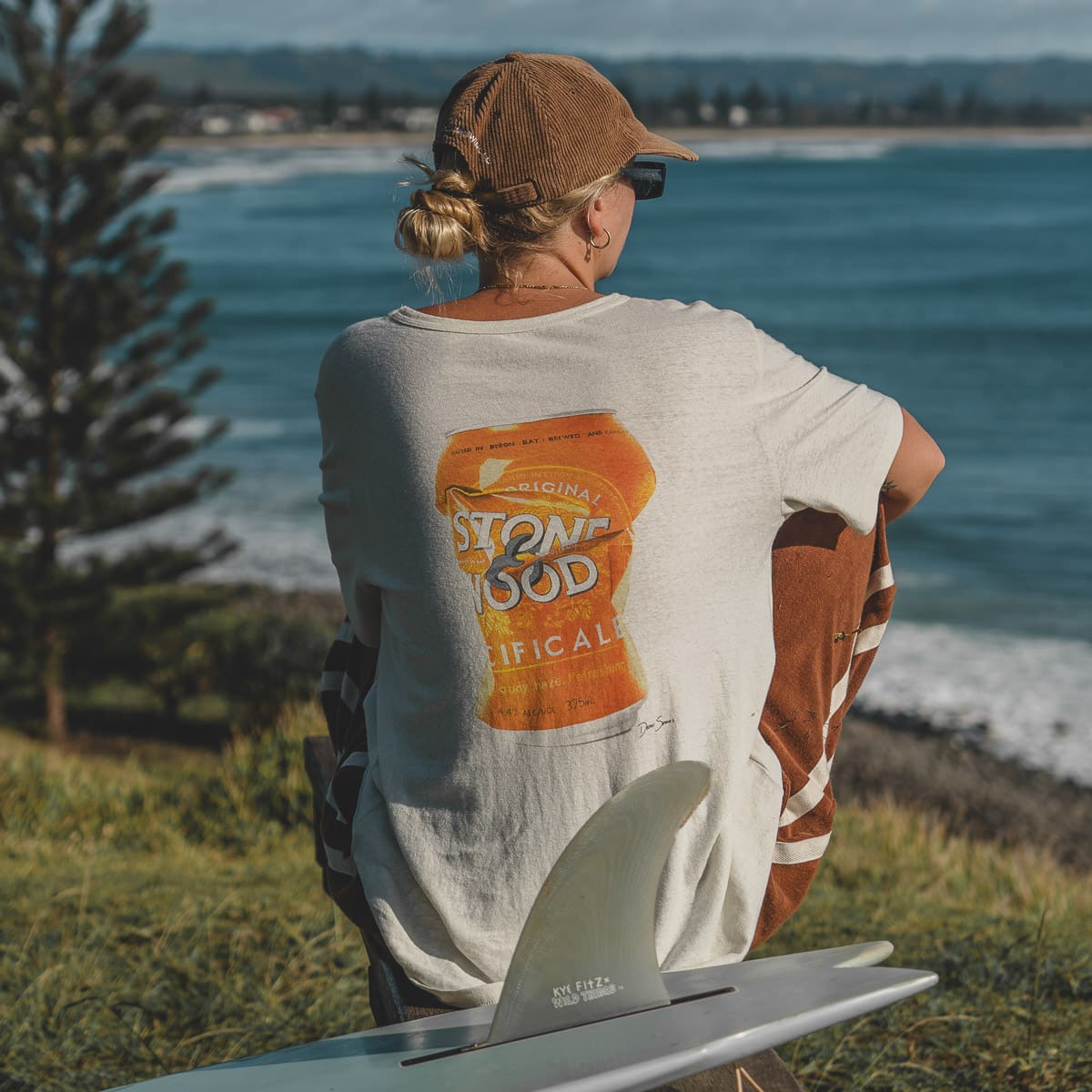 Girl looks over surf break wearing Stone & Wood Dean Spinks beer can shirt