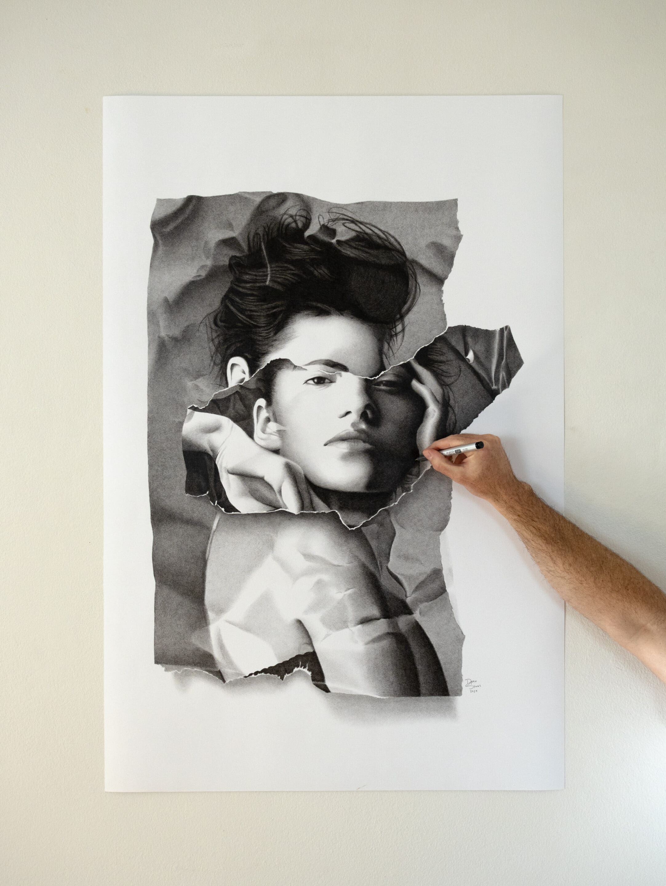 Artist holding a Copic Marker while working on "The Forbidden Enigma", showing the fine crosshatching technique.